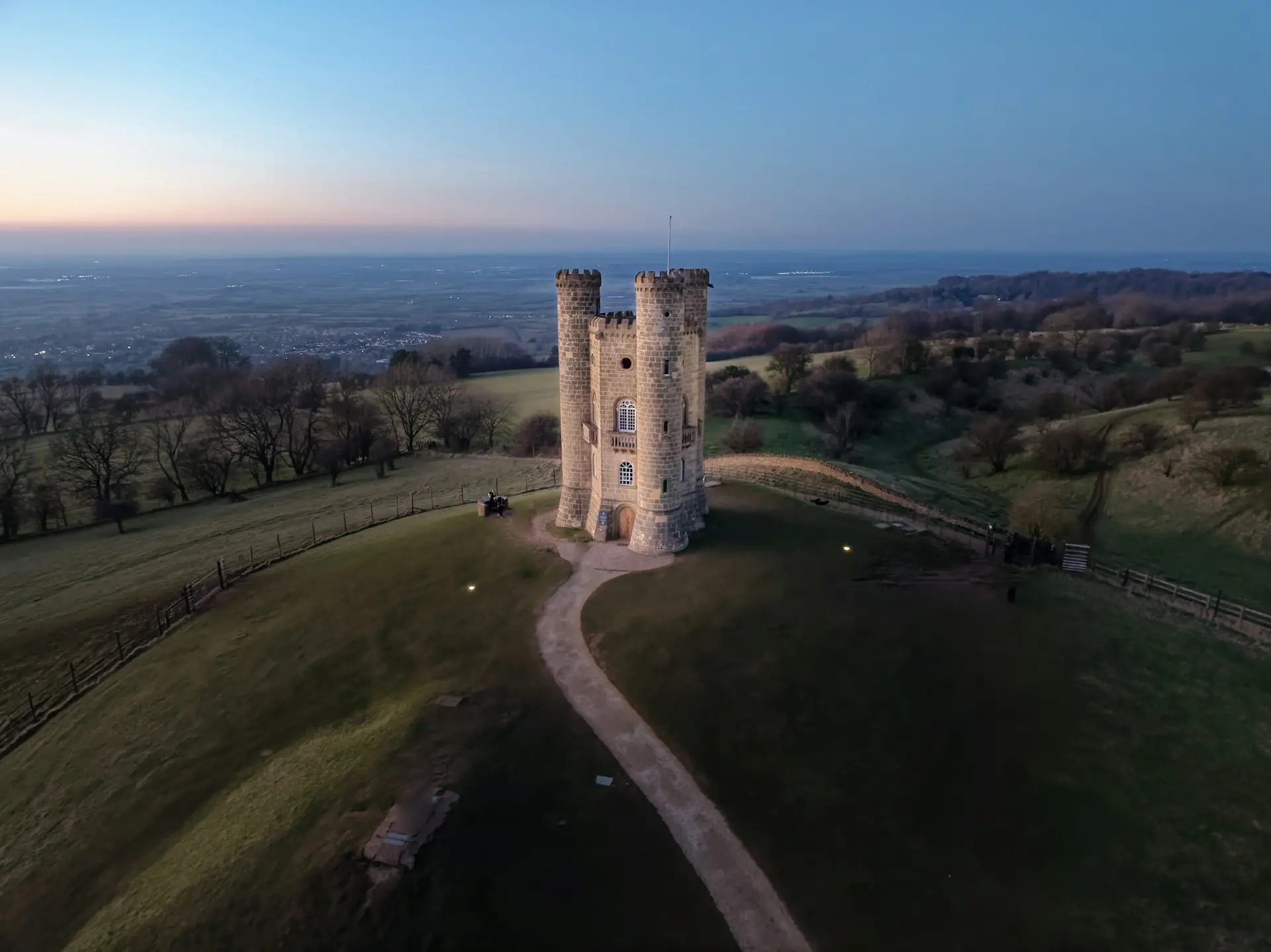 Broadway Tower on the hilltop at sunset, a landmark visible from the northern stages