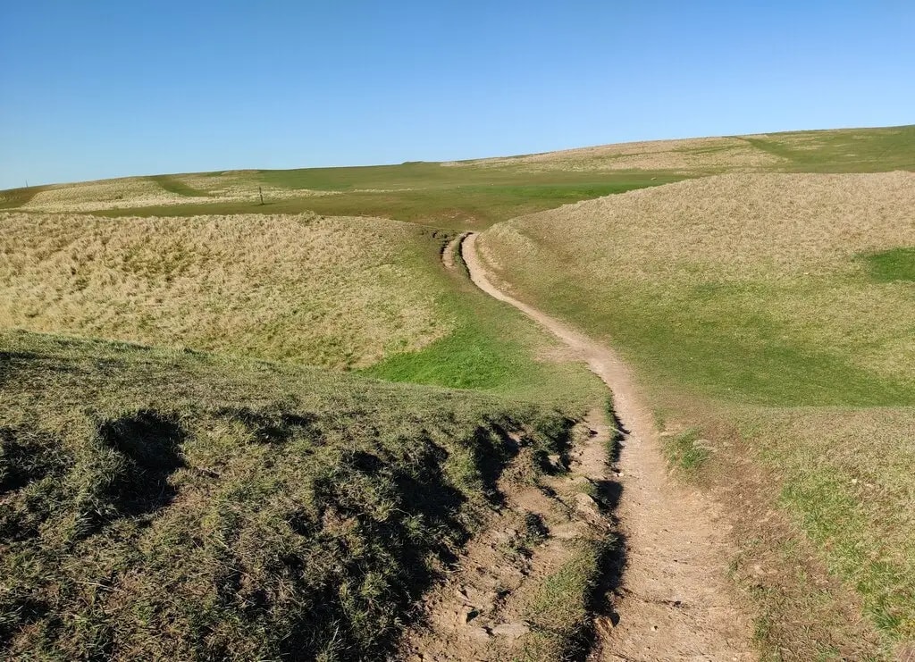 Open grassland path across Cleeve Hill Common, the highest point on the trail